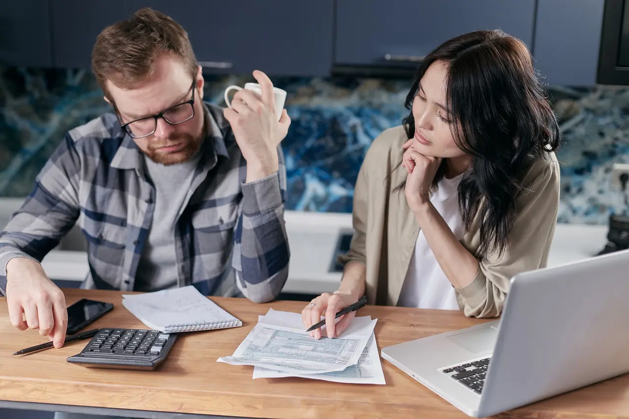 A young couple going through bills